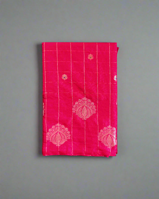 Pink fabric with white patterns on a gray textured background