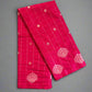Red fabric with white patterns on a gray surface
