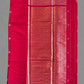 Red fabric with intricate patterns on a gray background