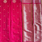 Red saree with gold patterns on a green background