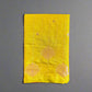 Yellow fabric with floral patterns on a textured gray surface