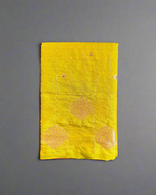Yellow fabric with floral patterns on a textured gray surface