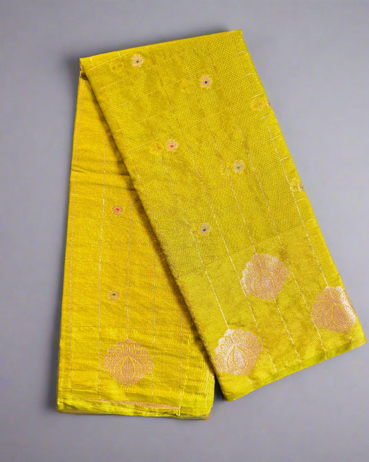 Yellow fabric with gold floral patterns on a gray surface
