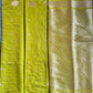 Green fabric with gold patterns on a dark background