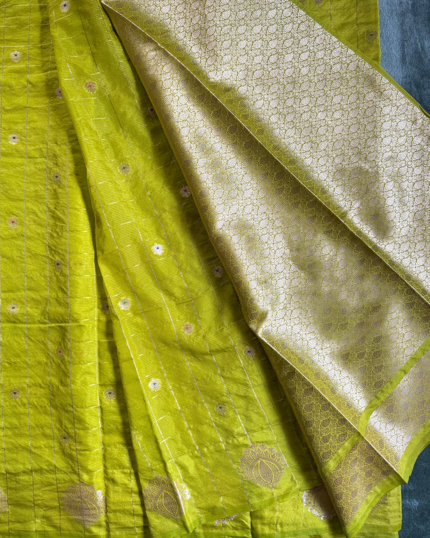 Close-up of green fabric with gold patterns