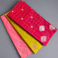 Three colorful fabric samples with patterns on a textured surface