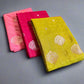 Stack of colorful fabric pieces on a textured surface