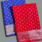 Two sarees, one blue and one red, with white patterns on a gray background