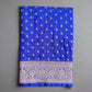 Blue fabric with white patterns and a decorative border on a gray background
