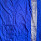 Blue fabric with a decorative border on a plain background