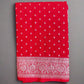 Red fabric with white patterns on a gray surface