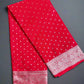 Red fabric with white patterns on a gray surface