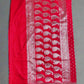 Red fabric with white pattern on a gray background