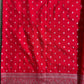 Red fabric with white patterns and a decorative border