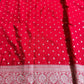 Red fabric with white polka dots and a decorative border