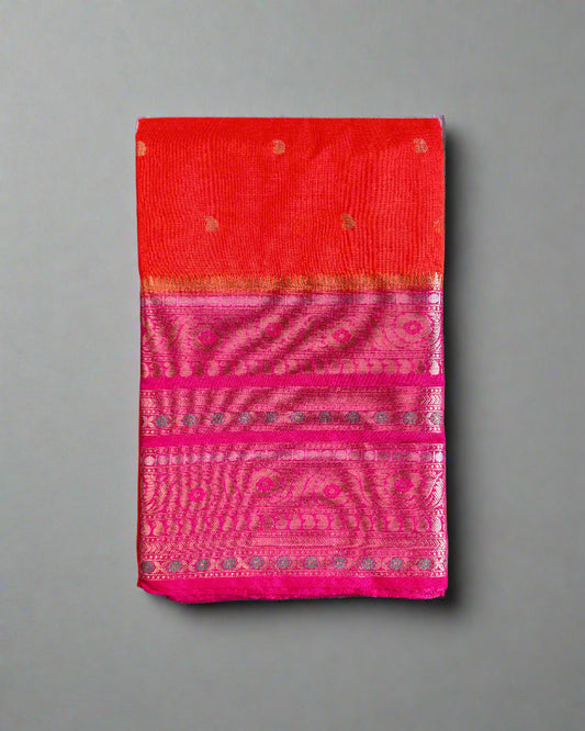 Red and pink saree with a textured pattern on a gray surface