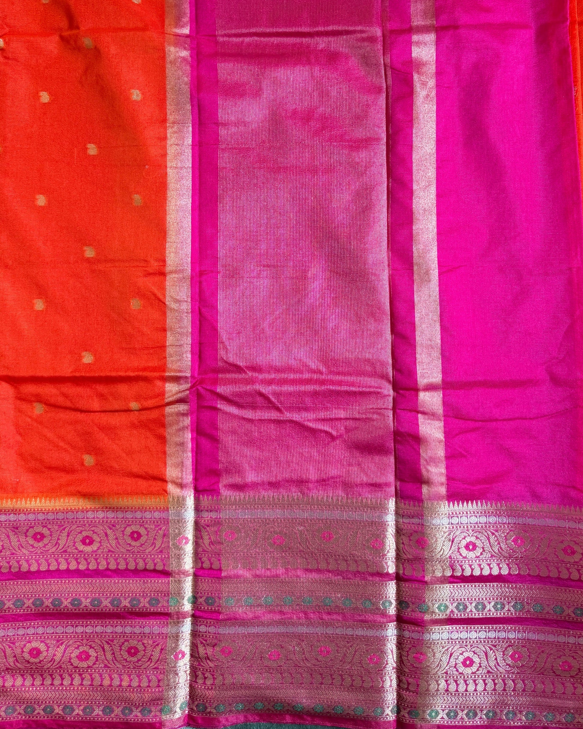 Saree with pink and orange patterned border on a plain background