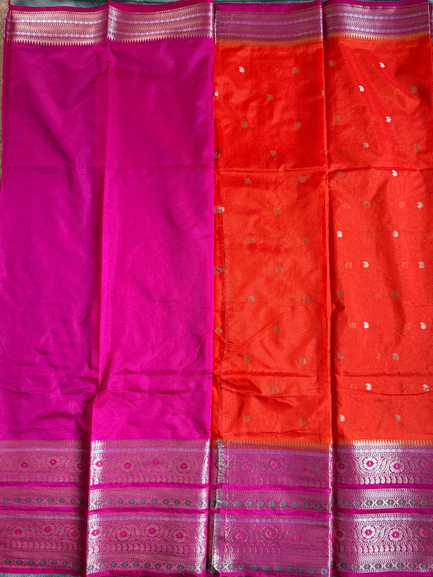 Red and pink saree with a pattern on a green surface