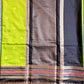 Saree with a black, brown, and green pattern on a light blue fabric background