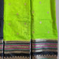 Green fabric with intricate patterns on a dark background