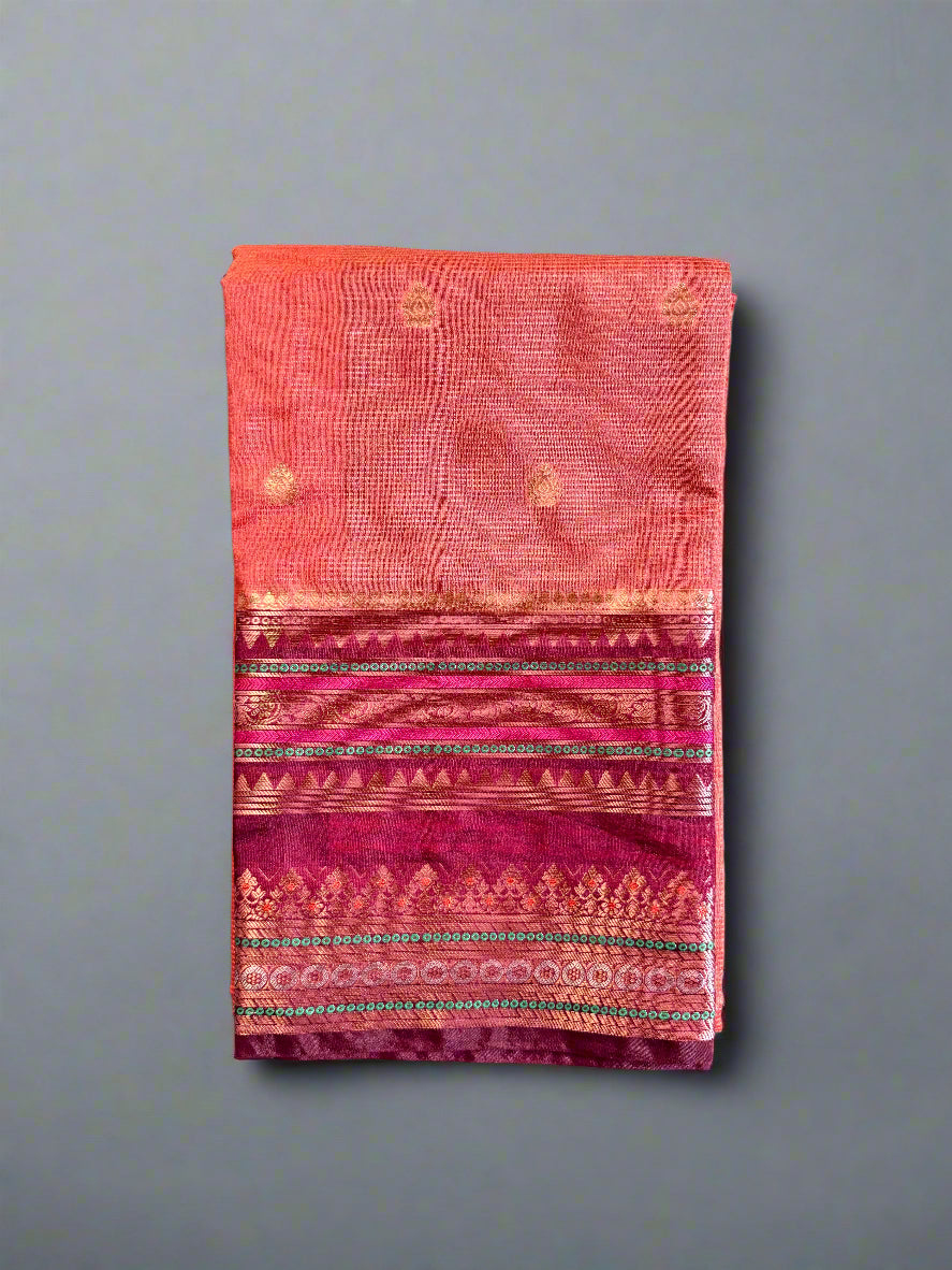 Folded fabric with pink and red patterns on a gray surface