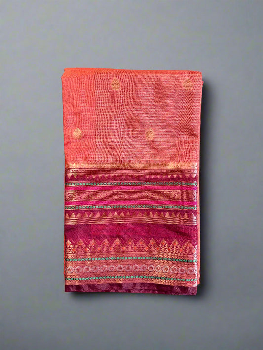 Folded fabric with pink and red patterns on a gray surface