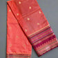 Red fabric with gold patterns on a gray background