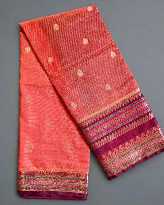 Red fabric with gold patterns on a gray background