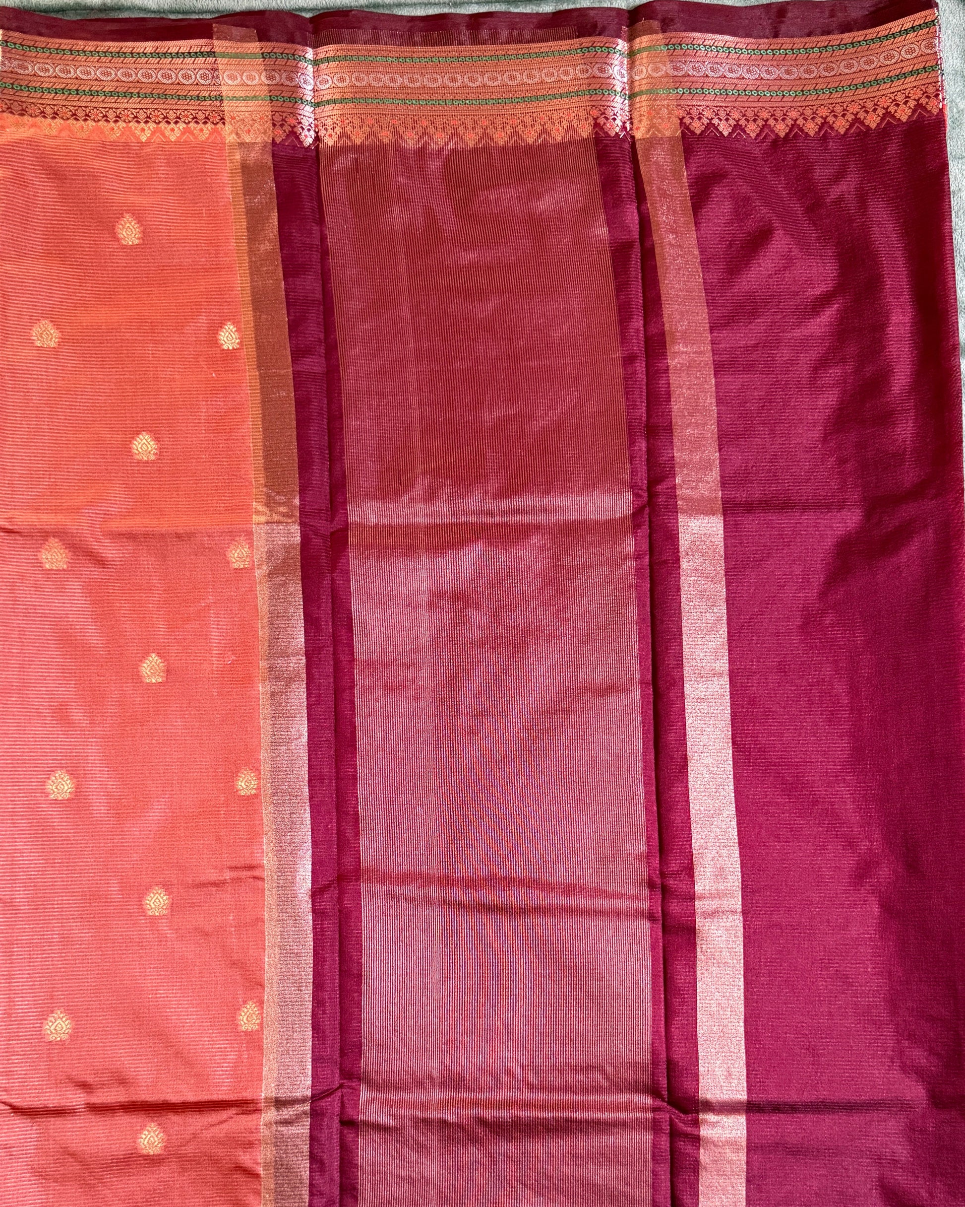 Saree with a checkered pattern on a green background