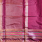 Close-up of a maroon fabric with decorative patterns