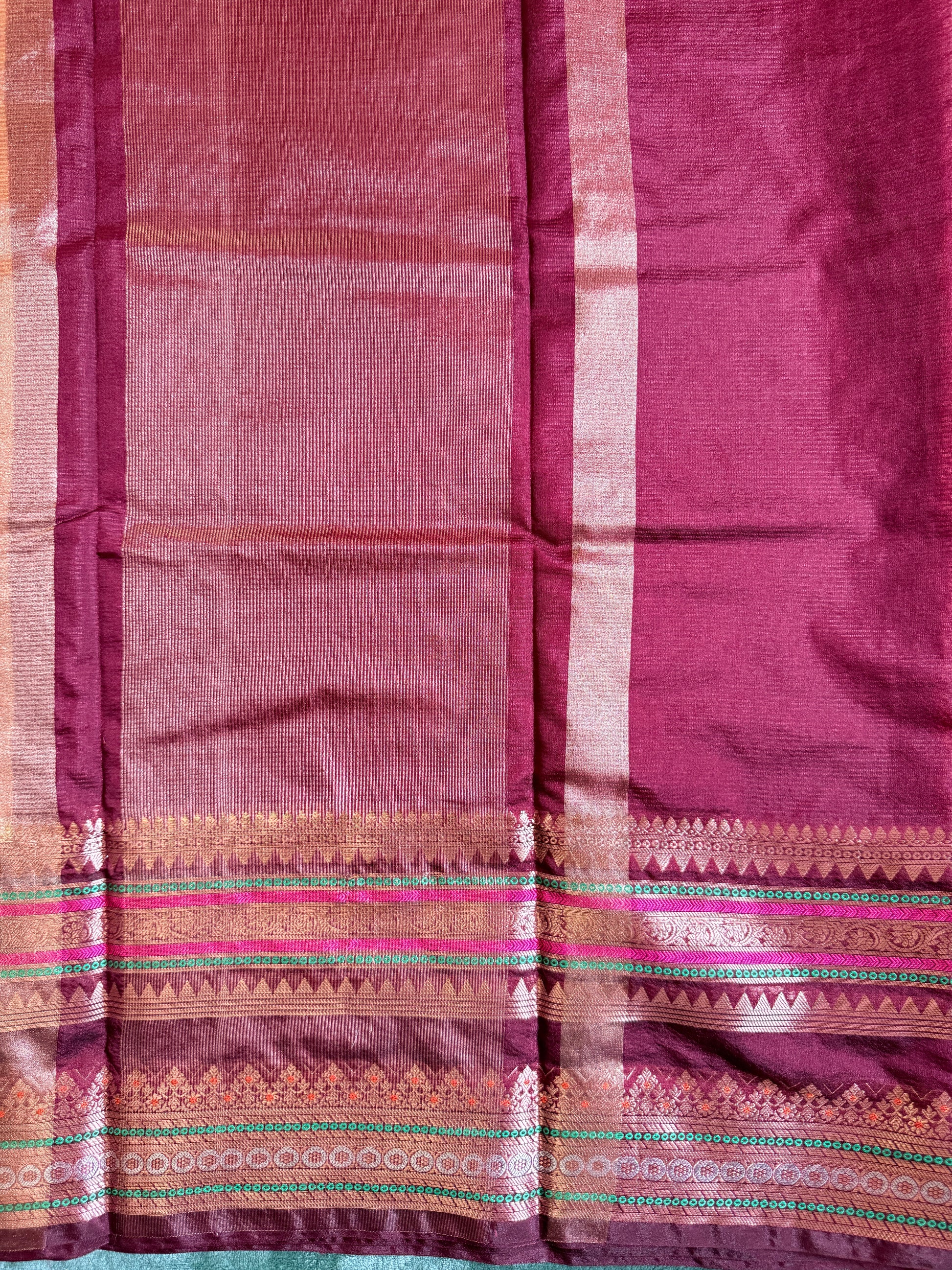 Close-up of a maroon fabric with decorative patterns
