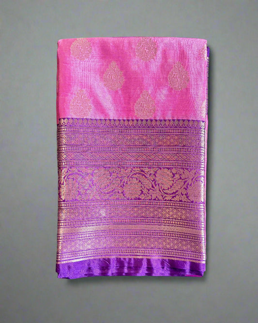 Pink and purple fabric with intricate patterns on a gray surface