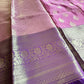 Purple and pink saree with intricate patterns on a fabric surface