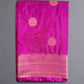 Purple saree with pink border on a gray surface