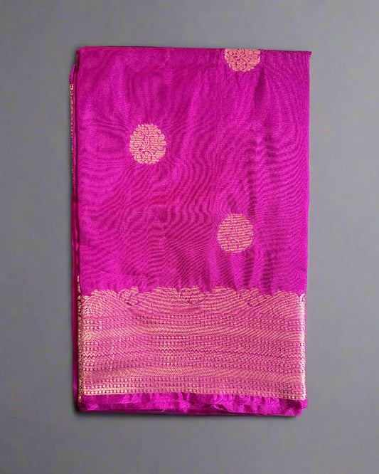 Purple saree with pink border on a gray surface