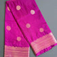 Purple fabric with pink border and patterns on a textured gray background