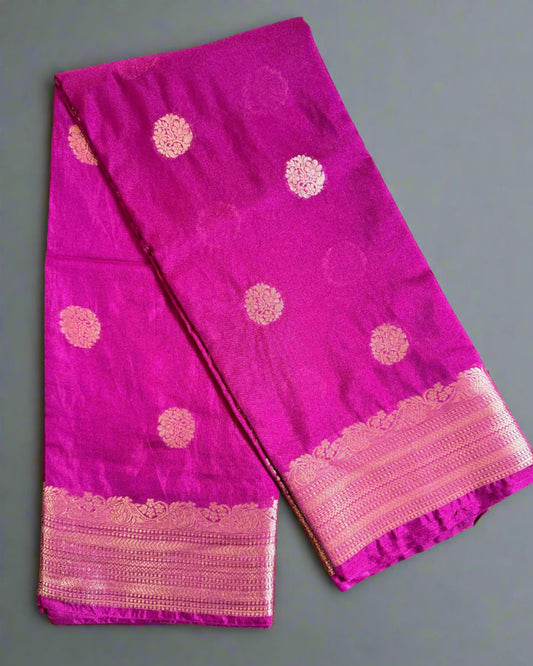 Purple fabric with pink border and patterns on a textured gray background