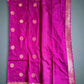 Purple saree with gold patterns on a gray background