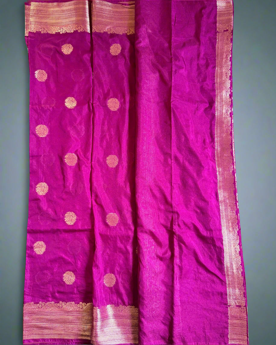 Purple saree with gold patterns on a gray background