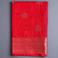 Red fabric with circular patterns on a gray textured background