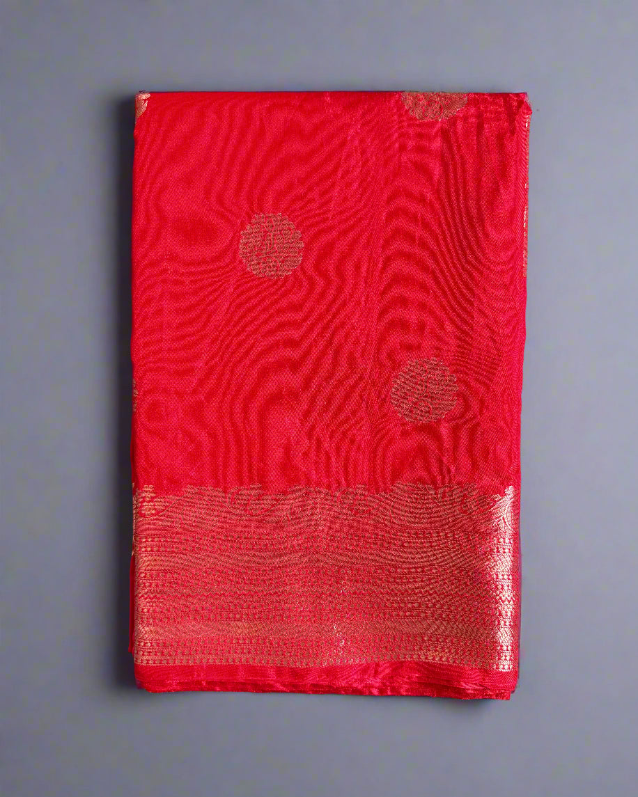 Red fabric with circular patterns on a gray textured background