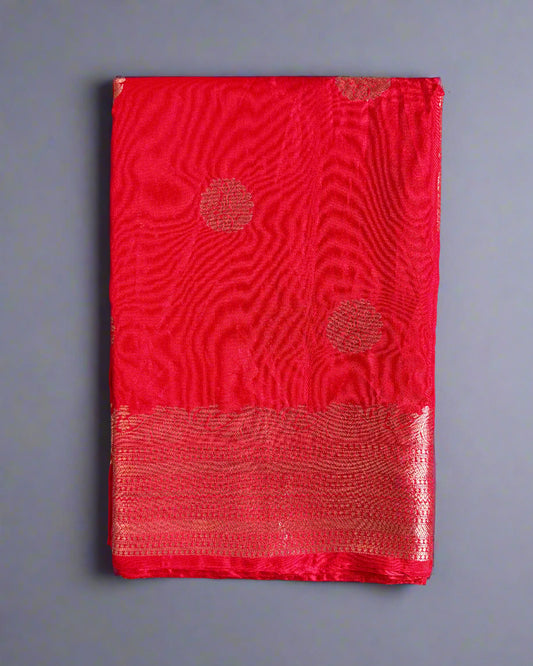 Red fabric with circular patterns on a gray textured background