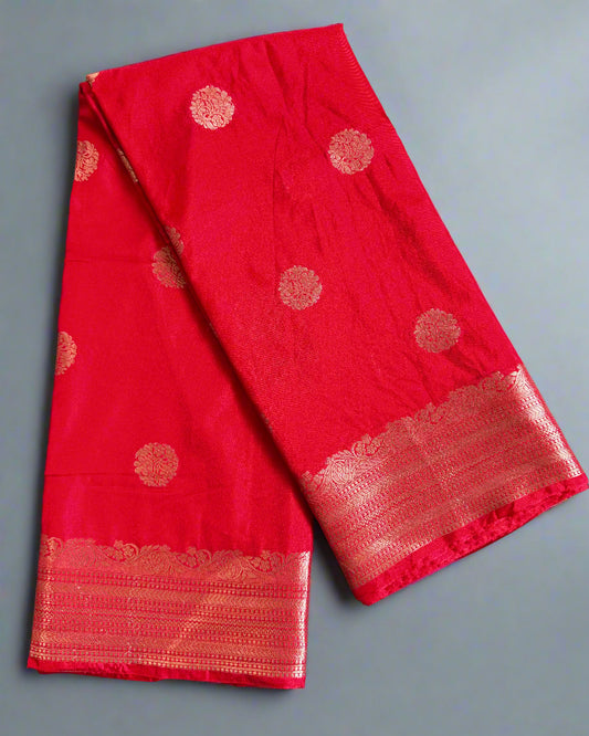 Red fabric with gold patterns on a gray surface