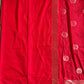 Red fabric with white dot patterns on a gray surface