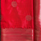 Red fabric with gold patterns on a gray surface