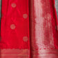 Red fabric with gold patterns on a gray surface
