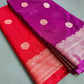 Purple and red sarees with gold patterns on a gray surface