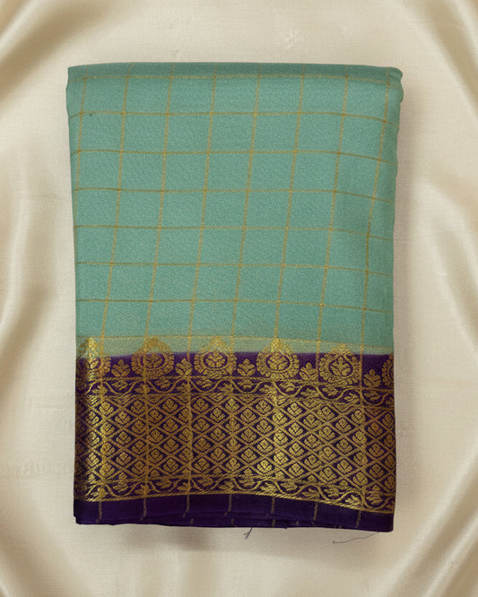 Teal fabric with gold and purple border on a white background