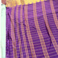 Purple and gold checkered fabric with a plain background