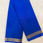 Blue saree with a gold border on a white background